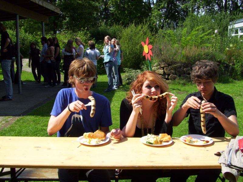 Jock, Evie and Laurence showing varying levels of enthusiasm for the Wurst